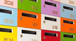 mail slots for an apartment building in a variety of colors